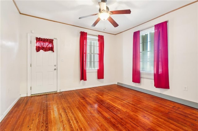 empty room with hardwood / wood-style flooring, ceiling fan, and crown molding