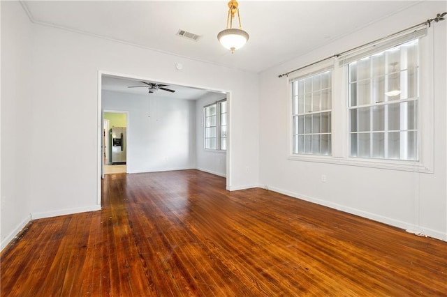 empty room featuring ceiling fan and dark hardwood / wood-style flooring