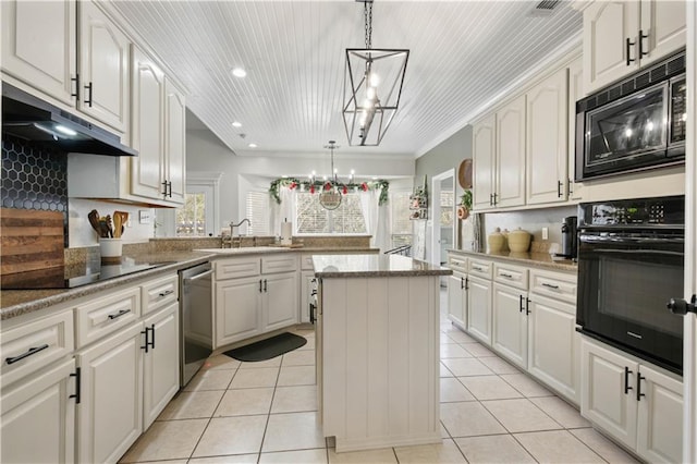 kitchen with sink, black appliances, white cabinets, a kitchen island, and hanging light fixtures