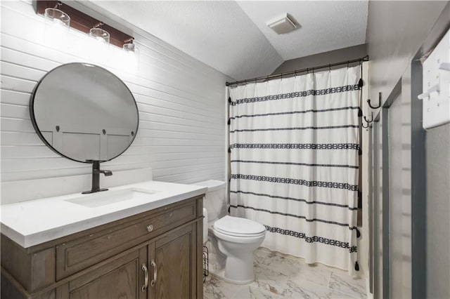 bathroom featuring vanity, a textured ceiling, toilet, and wood walls