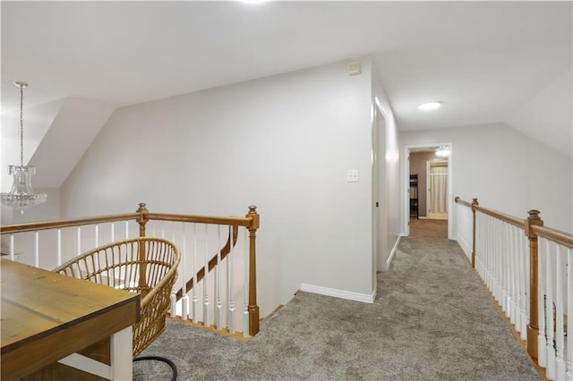 corridor with carpet floors, an inviting chandelier, and lofted ceiling