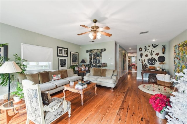 living room featuring hardwood / wood-style floors and ceiling fan