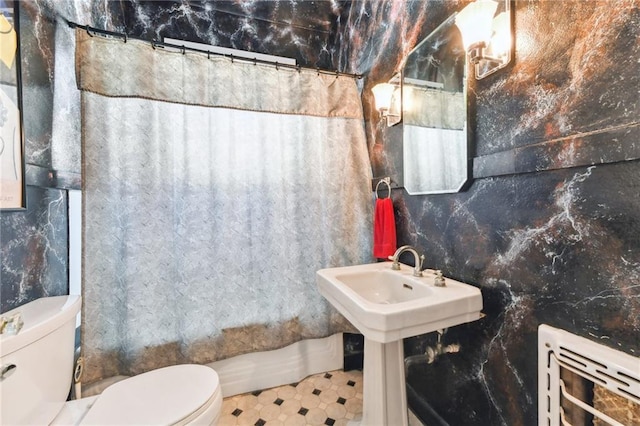 bathroom with a shower with curtain and toilet