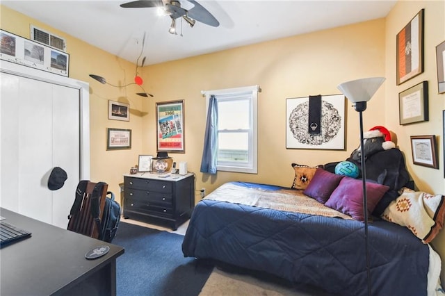 carpeted bedroom featuring a closet and ceiling fan