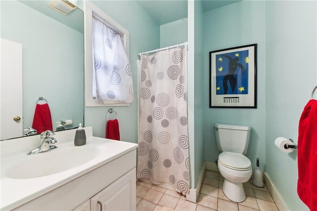 bathroom featuring tile patterned floors, vanity, and toilet