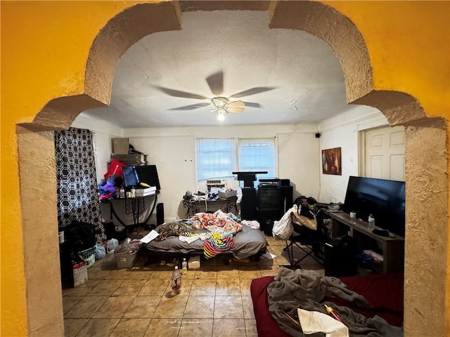 misc room featuring ceiling fan and tile patterned flooring