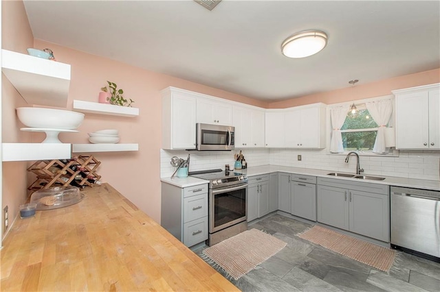 kitchen featuring gray cabinets, sink, white cabinets, and appliances with stainless steel finishes