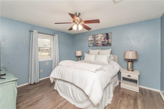 bedroom with hardwood / wood-style flooring and ceiling fan