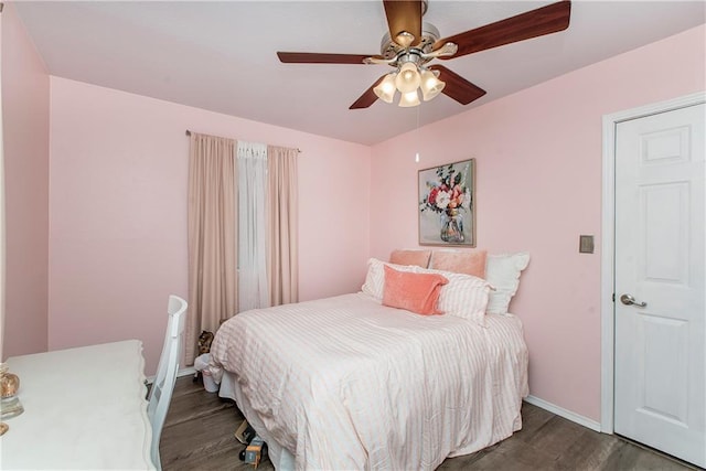 bedroom with ceiling fan and dark wood-type flooring