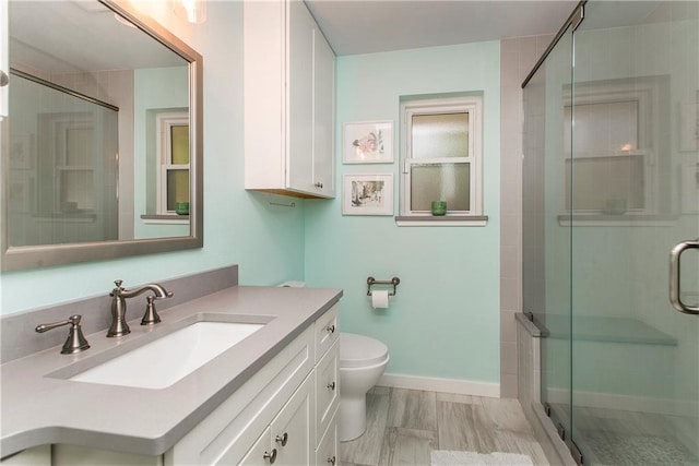 bathroom with vanity, toilet, and walk in shower