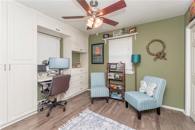 home office featuring light wood-type flooring and ceiling fan