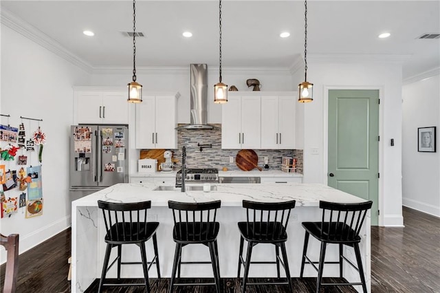 kitchen with white cabinets, dark hardwood / wood-style floors, wall chimney range hood, and an island with sink