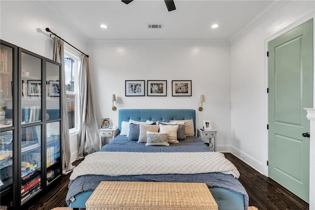 bedroom with dark hardwood / wood-style floors, ceiling fan, and crown molding