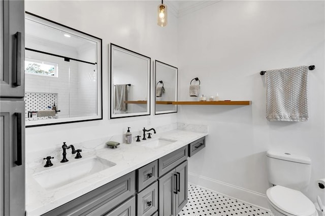 bathroom featuring an enclosed shower, vanity, toilet, and crown molding