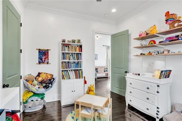 recreation room featuring dark hardwood / wood-style floors and crown molding