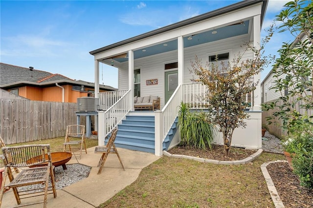 view of front of property with a porch and central air condition unit