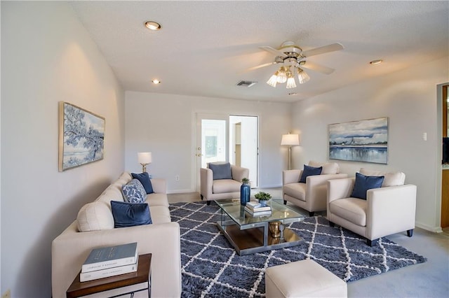 living room featuring ceiling fan and carpet