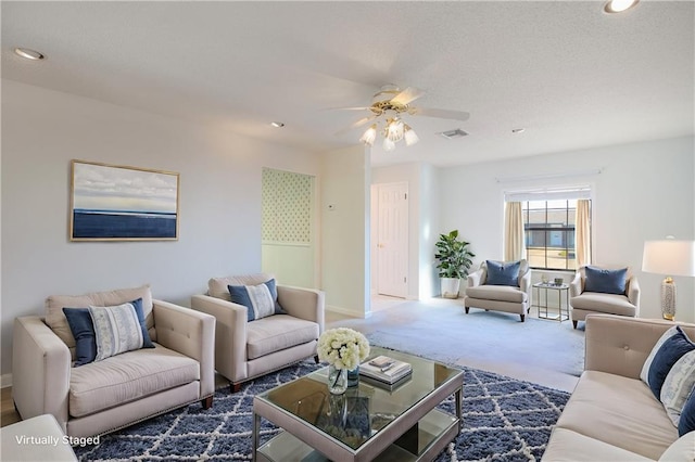 carpeted living room with ceiling fan