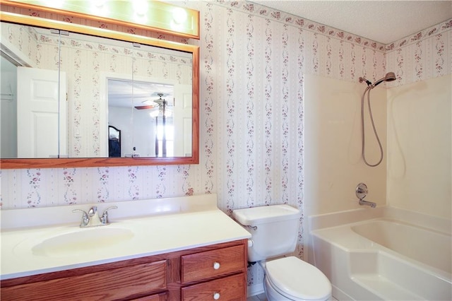 full bathroom with vanity, shower / washtub combination, ceiling fan, toilet, and a textured ceiling