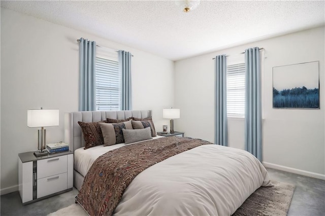 bedroom featuring light carpet and a textured ceiling