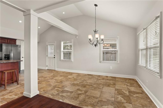 unfurnished dining area featuring ornate columns, dark wood-type flooring, vaulted ceiling, and an inviting chandelier