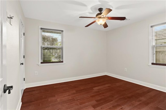 unfurnished room with ceiling fan and dark hardwood / wood-style flooring