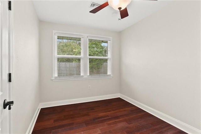 spare room featuring dark hardwood / wood-style flooring and ceiling fan