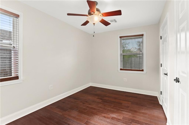 unfurnished room with dark hardwood / wood-style floors, ceiling fan, and a wealth of natural light