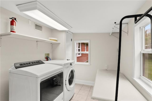 washroom featuring light tile patterned floors and independent washer and dryer