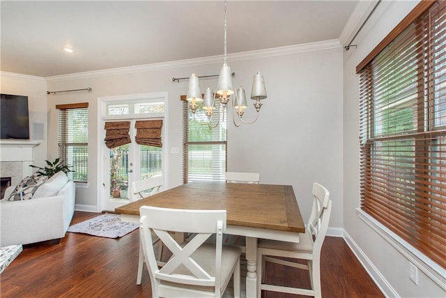 dining space with an inviting chandelier, ornamental molding, wood finished floors, and baseboards