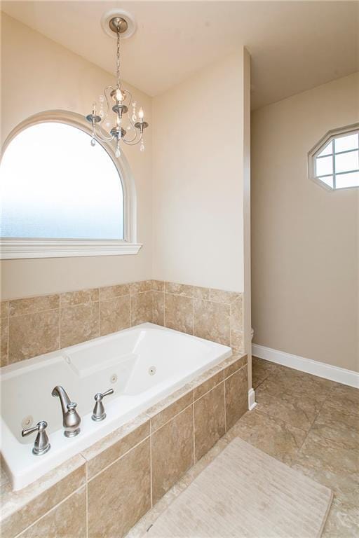 full bath with a chandelier and a whirlpool tub