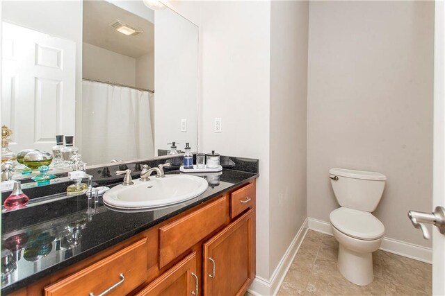 bathroom with tile patterned floors, toilet, baseboards, visible vents, and vanity