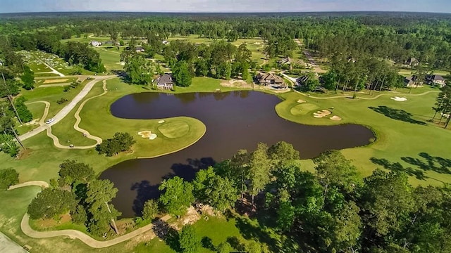 birds eye view of property featuring view of golf course, a wooded view, and a water view