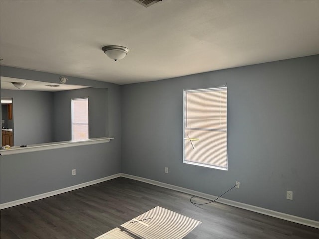 unfurnished room with dark hardwood / wood-style floors