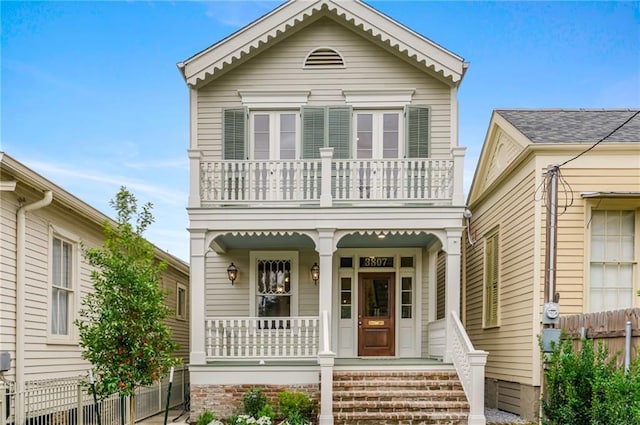 view of front facade featuring covered porch and a balcony