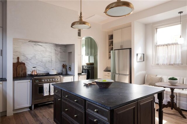 kitchen with dark countertops, dark wood-style floors, and stainless steel appliances