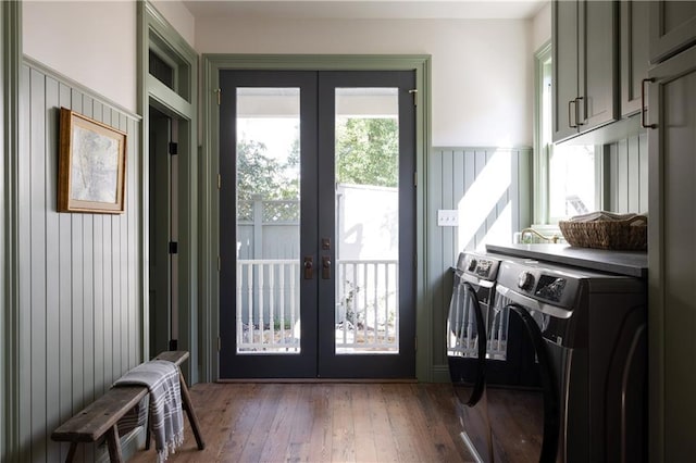 laundry room featuring washer and clothes dryer, cabinet space, french doors, and hardwood / wood-style flooring