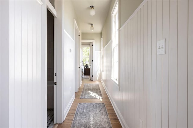 hall featuring baseboards and wood finished floors