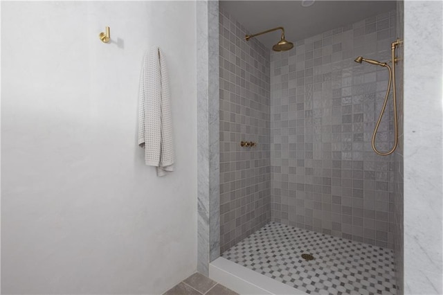 full bathroom with tile patterned floors and a tile shower