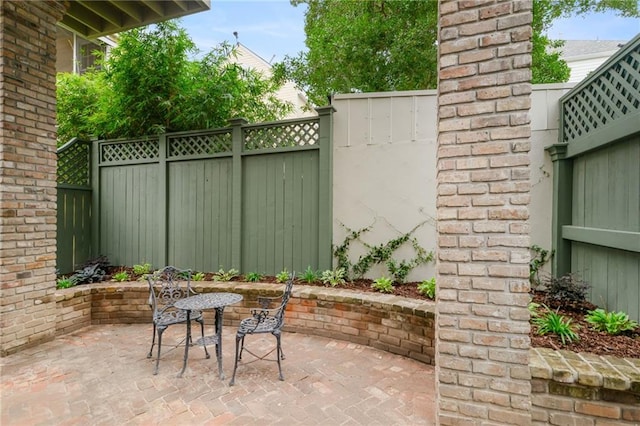 view of patio featuring outdoor dining area and a fenced backyard