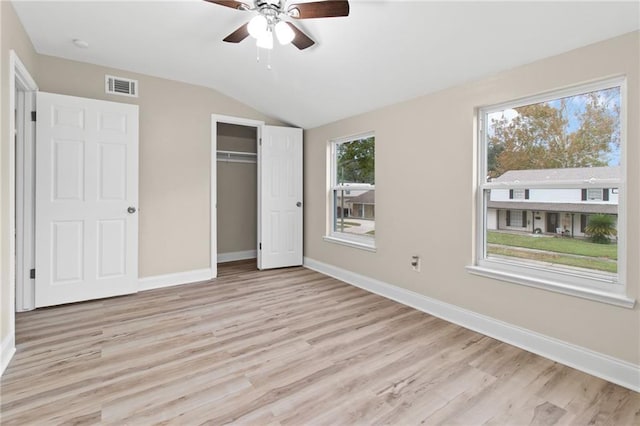 unfurnished bedroom with light hardwood / wood-style floors, multiple windows, and ceiling fan