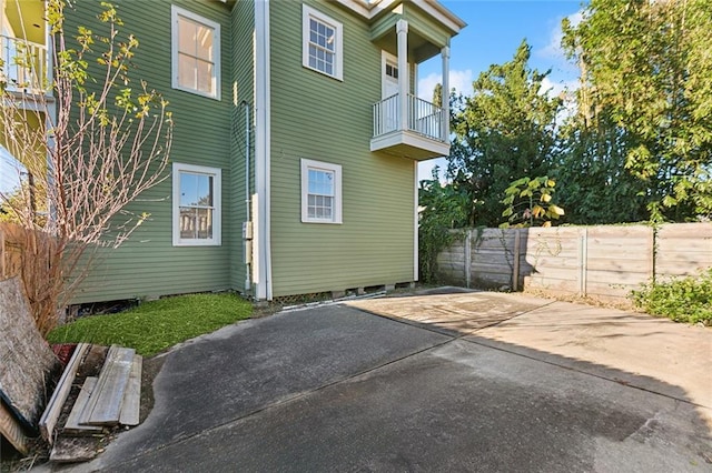 view of side of property featuring a balcony