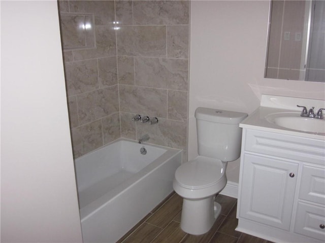 full bathroom featuring vanity, toilet, and tiled shower / bath