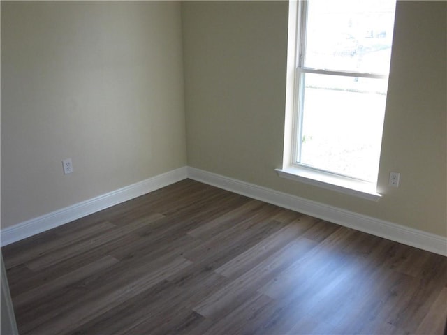 spare room featuring dark hardwood / wood-style flooring