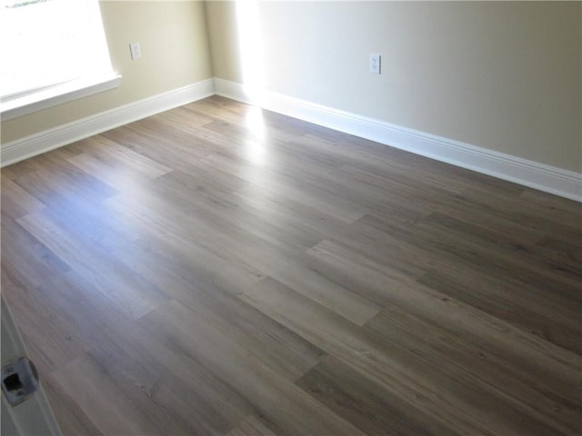 empty room featuring dark wood-type flooring