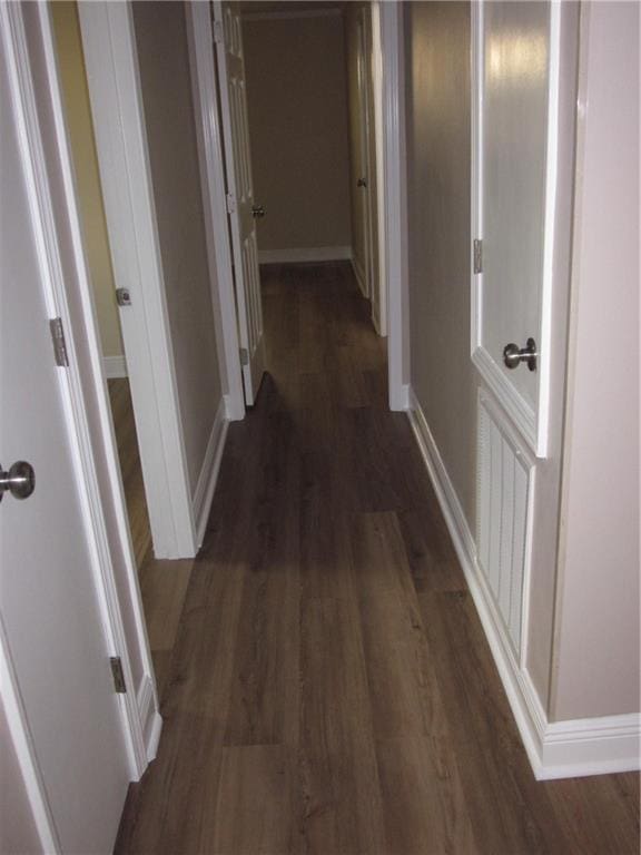 corridor featuring dark hardwood / wood-style flooring