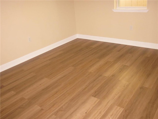 empty room with hardwood / wood-style floors