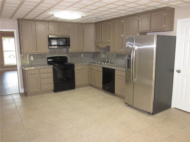 kitchen with decorative backsplash, sink, and black appliances