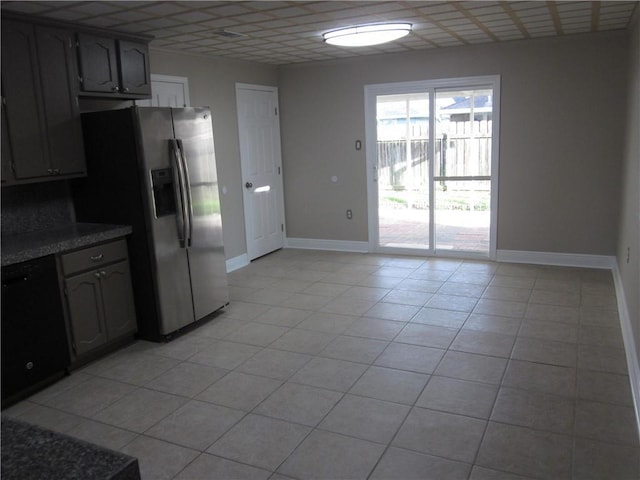 kitchen with a drop ceiling, black dishwasher, stainless steel fridge with ice dispenser, gray cabinets, and light tile patterned floors