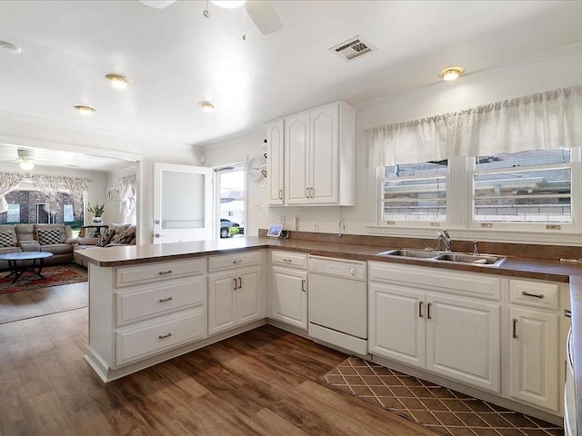 kitchen featuring sink, dark hardwood / wood-style flooring, kitchen peninsula, white dishwasher, and white cabinets